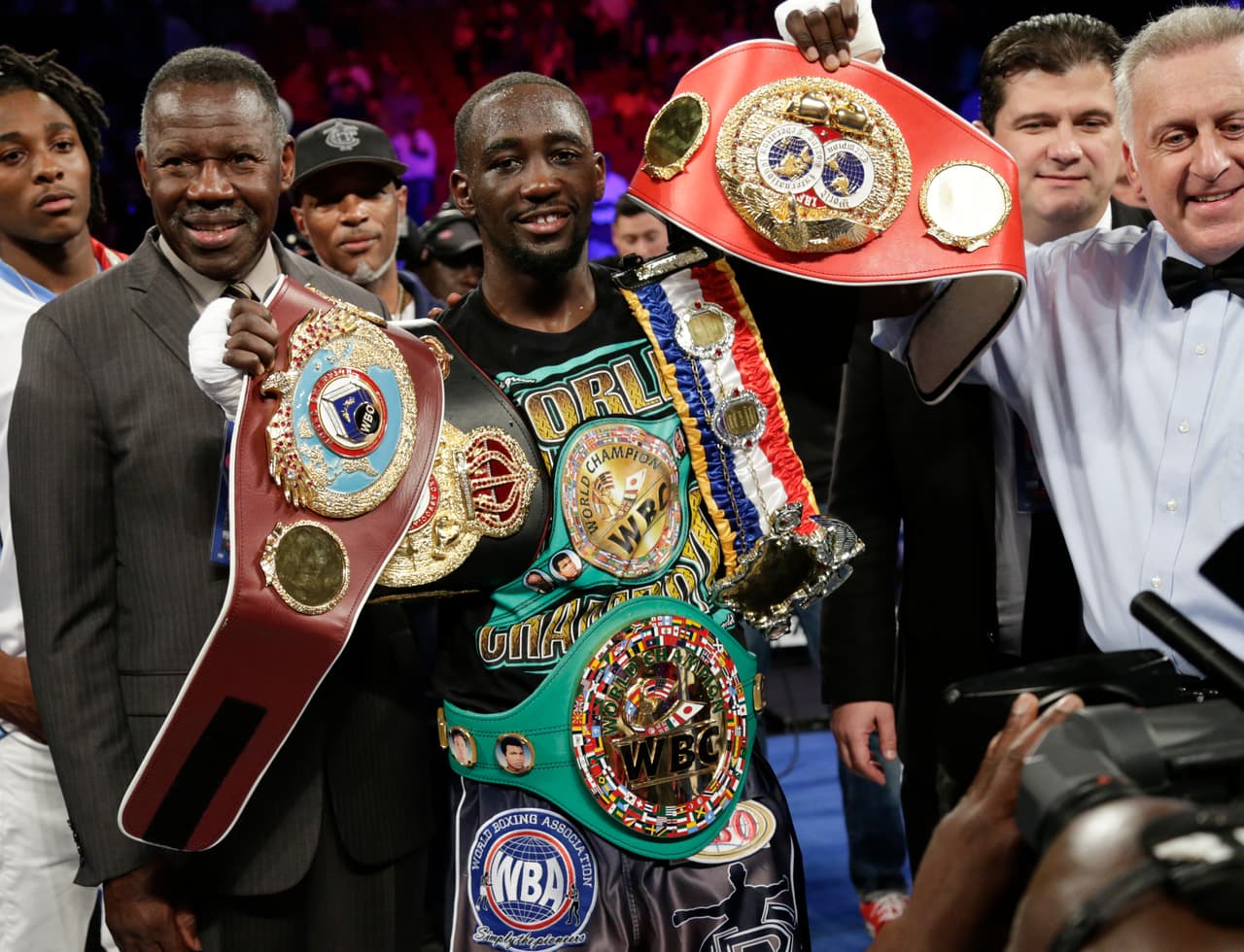 CORRECTS TO THIRD ROUND, INSTEAD OF SECOND - Terence "Bud" Crawford celebrates his victory by knockout over Julius Indongo in the third round of a junior welterweight world title unification boxing bout in Lincoln, Neb., Saturday, Aug. 19, 2017. (AP Photo/Nati Harnik)