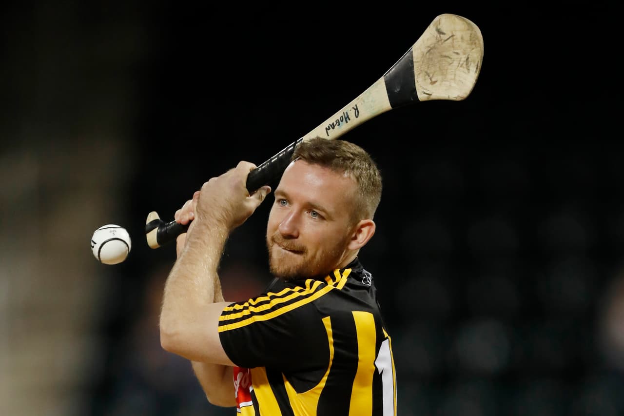 In this Tuesday, Sept. 24, 2019, photo, Kilkenny hurler Richie Hogan "throws" out the ceremonial first pitch before a baseball game between the New York Mets and the Miami Marlins in New York. New York will host the New York Hurling Classic, in which four professional hurling teams from Ireland are scheduled to compete, Nov. 16 at Citi Field. (AP Photo/Kathy Willens)
