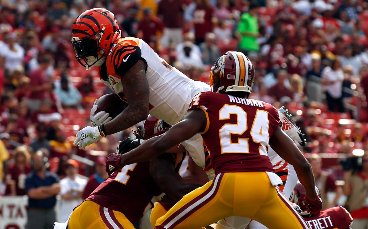 Cincinnati Bengals running back Jeremy Hill, left, dives into the end zone for a touchdown in front of Washington Redskins cornerback Josh Norman (24) in the first half of a preseason NFL football game, Sunday, Aug. 27, 2017, in Landover, Md. (AP Photo/Alex Brandon)