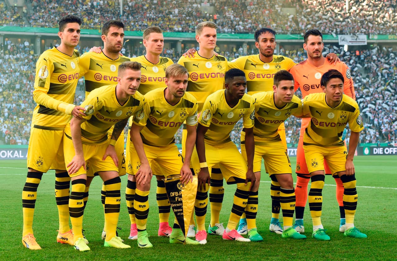 Dortmund's team poses for a group picture prior the German Cup (DFB Pokal) final football match Eintracht Frankfurt v BVB Borussia Dortmund at the Olympic stadium in Berlin on May 27, 2017. (Front row, From L) Dortmund's forward Marco Reus, Dortmund's defender Marcel Schmelzer, Dortmund's French midfielder Ousmane Dembele, Dortmund's Portuguese defender Raphael Guerreiro and Dortmund's Japanese midfielder Shinji Kagawa. (Back row, From L) Dortmund's Spanish defender Marc Bartra, Dortmund's Greek defender Sokratis, Dortmund's Polish defender Lukasz Piszczek, Dortmund's defender Matthias Ginter, Dortmund's Gabonese forward Pierre-Emerick Aubameyang and Dortmund's Swiss goalkeeper Roman Buerki. / AFP PHOTO / Christof STACHE / RESTRICTIONS: ACCORDING TO DFB RULES IMAGE SEQUENCES TO SIMULATE VIDEO IS NOT ALLOWED DURING MATCH TIME. MOBILE (MMS) USE IS NOT ALLOWED DURING AND FOR FURTHER TWO HOURS AFTER THE MATCH. == RESTRICTED TO EDITORIAL USE == FOR MORE INFORMATION CONTACT DFB DIRECTLY AT +49 69 67880 / (Photo credit should read CHRISTOF STACHE/AFP/Getty Images)