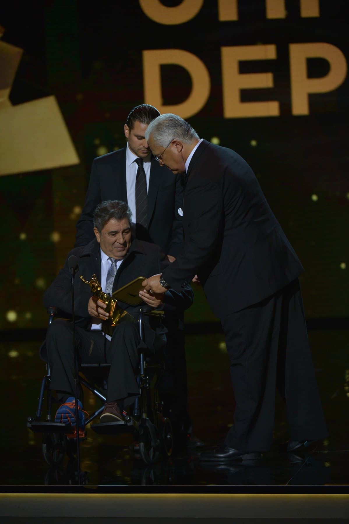 El estratega acudió al escenario en una silla de ruedas debido a molestias físicas que no impidieron que asistiera a la premiación.
