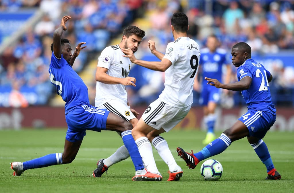 LEICESTER, ENGLAND - AUGUST 18: Ruben Neves and Raul Jimenez of Wolverhampton Wanderers battle for the ball with Onyinye Wilfred Ndidi and Nampalys Mendy of Leicester City during the Premier League match between Leicester City and Wolverhampton Wanderers at The King Power Stadium on August 18, 2018 in Leicester, United Kingdom. (Photo by Michael Regan/Getty Images)