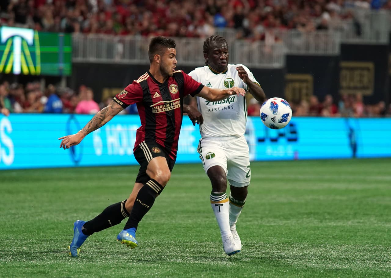 Jun 24, 2018; Atlanta, GA, USA; Atlanta United forward Hector Villalba (15) battles for the ball against Portland Timbers midfielder Diego Chara (21) during the second half at Mercedes-Benz Stadium. Mandatory Credit: Adam Hagy-USA TODAY Sports