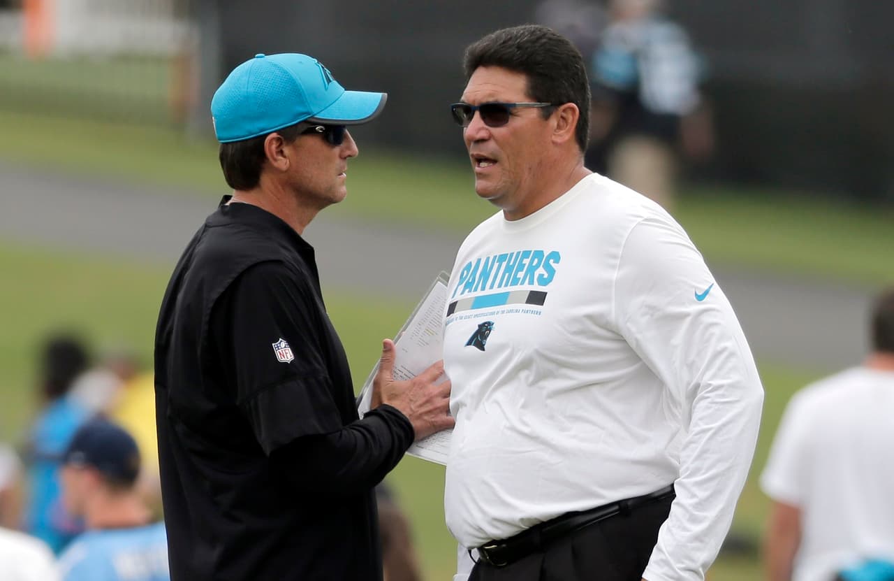 Carolina Panthers head coach Ron Rivera, right, talks with offensive coordinator Mike Shula, left, during practice at the NFL team's football training camp at Wofford College in Spartanburg, S.C., Wednesday, Aug. 2, 2017. (AP Photo/Chuck Burton)