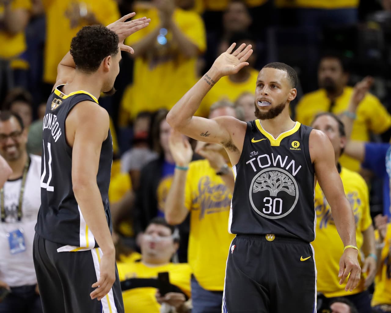Golden State Warriors guard Stephen Curry (30) celebrates with guard Klay Thompson (11) during the second half of Game 2 of basketball's NBA Finals in Oakland, Calif., Sunday, June 3, 2018. (AP Photo/Marcio Jose Sanchez)