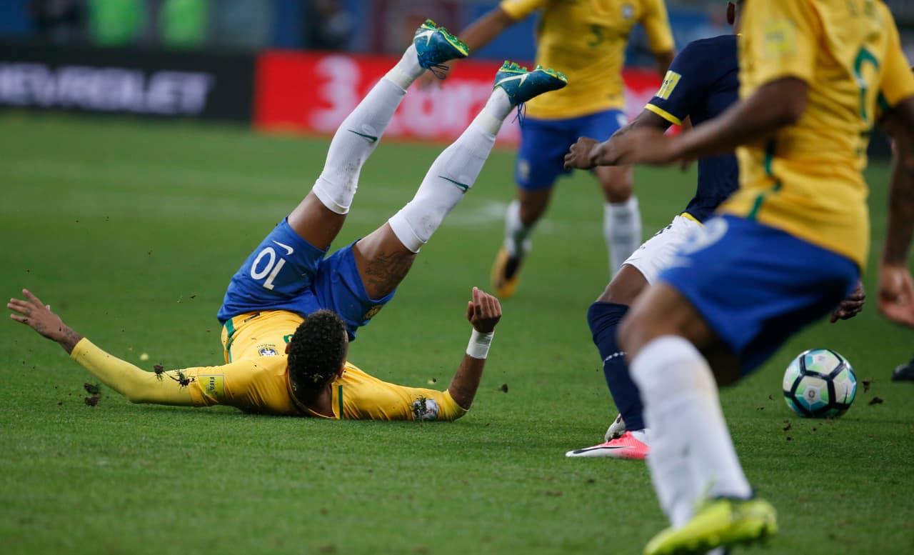 Brazil's Neymar, left, is taken down during a World Cup qualifying soccer match against Ecuador, in Porto Alegre, Brazil, Thursday, Aug. 31 2017. (AP Photo/Leo Correa)