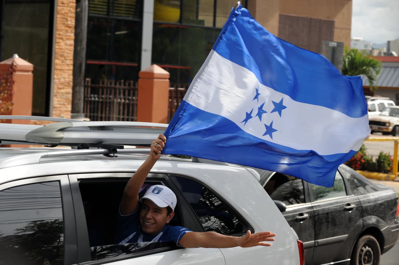 A supporters of the Honduran Olympic football team holds a Honduran national flag as he celebrates in Tegucigalpa on July 29, 2012, after Honduras defeated Spain by 1-0 in their London 2012 Olympic Games men's football match. AFP PHOTO / Orlando SIERRA (Photo credit should read ORLANDO SIERRA/AFP/GettyImages)