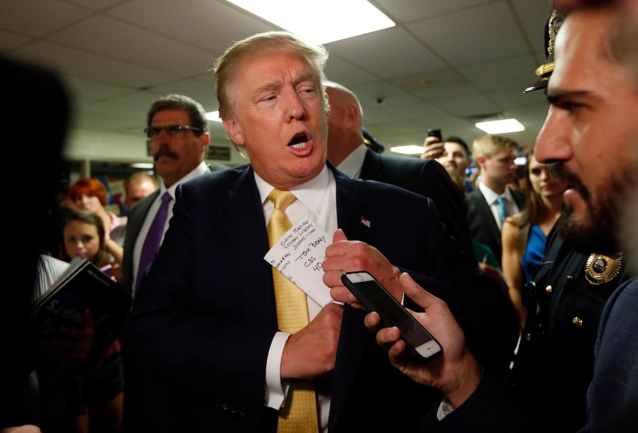 FILE - In this Sept. 17, 2015 file photo, a reference to New England Patriots quarterback Tom Brady is seen on the notes of Republican presidential candidate Donald Trump as he tucks his papers into his jacket as he arrives at a town hall event in Rochester, N.H. Brady says his comments that he hopes Donald Trump will win the presidency were taken out of context and an example of why he tries to say as little as possible when speaking publicly. (AP Photo/Robert F. Bukaty)