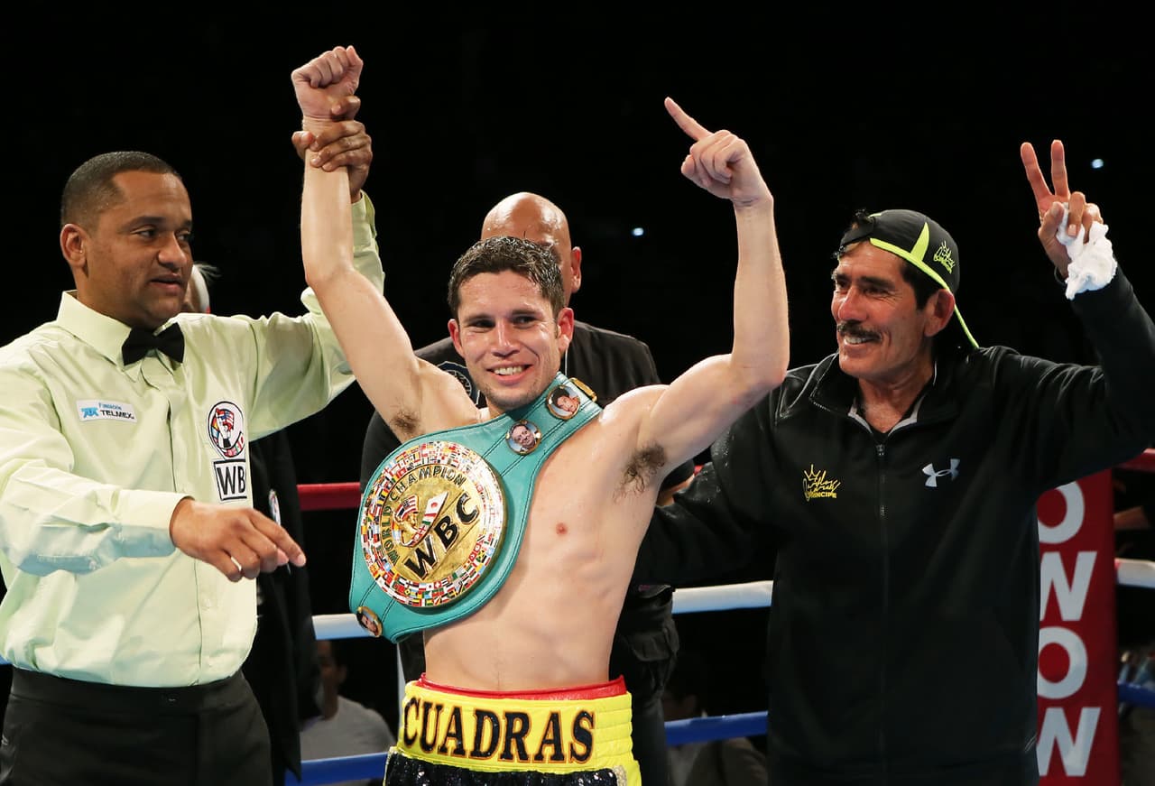 Mexican champion Carlos Cuadras (C) raises his fists in the air after retaining his champion's belt of the WBC super flyweight title boxing match in Sendai in Miyagi prefecture, northern Japan on November 28, 2015. Cuadras defeated Koki Eto of Japan by unanimous decision. AFP PHOTO / JIJI PRESS JAPAN OUT / AFP / JIJI PRESS / JIJI PRESS (Photo credit should read JIJI PRESS/AFP/Getty Images)