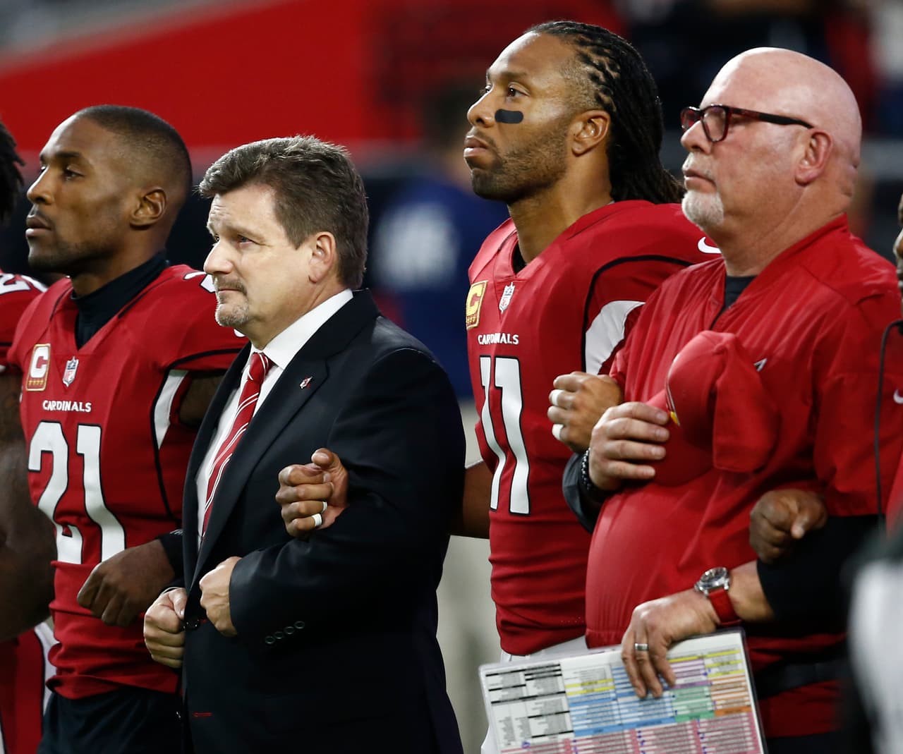 From left; Arizona Cardinals cornerback Patrick Peterson, president Michael Bidwill, wide receiver Larry Fitzgerald and head coach Bruce Arians stand during the national anthem prior to an NFL football game against the Dallas Cowboys, Monday, Sept. 25, 2017, in Glendale, Ariz. (AP Photo/Ross D. Franklin)