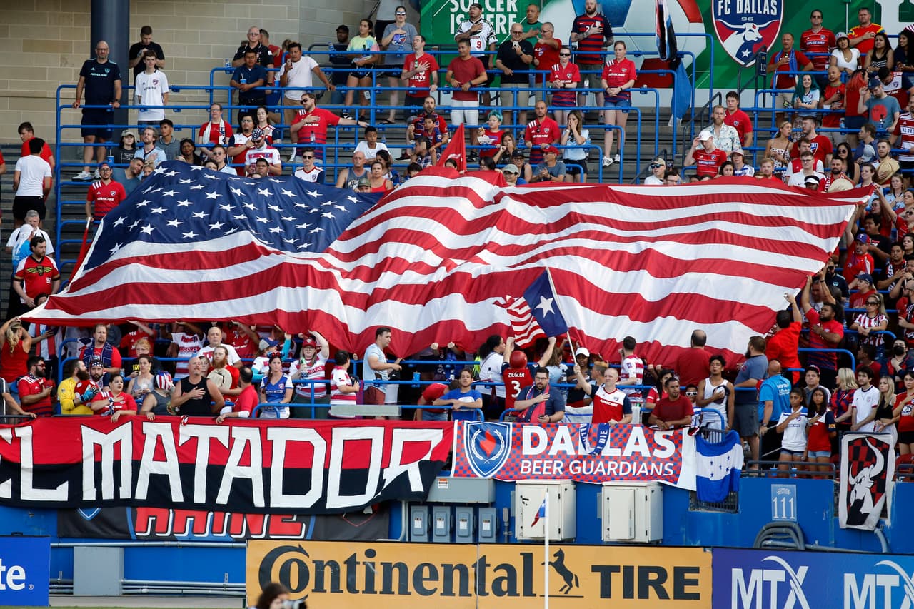 Jul 4, 2021; Frisco, Texas, USA; FC Dallas fans hold up an American flag before the match against the Vancouver Whitecaps at Toyota Stadium. Mandatory Credit: Tim Heitman-USA TODAY Sports