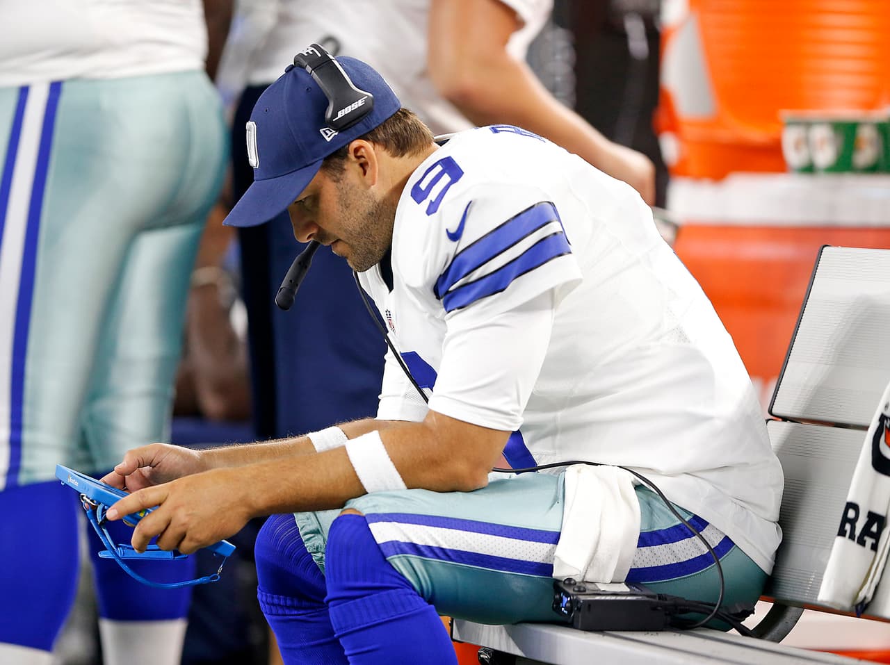 Dallas Cowboys quarterback Tony Romo (9) studies a video on a Microsoft Surface tablet on the bench during a preseason NFL game against the Miami Dolphins Friday, August 19, 2016, in Arlington, Texas. The Cowboys defeated the Dolphins, 41-14. (James D. Smith via AP)