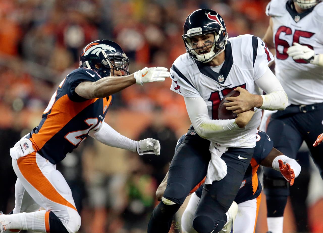 Houston Texans quarterback Brock Osweiler (17) runs for a first down as Denver Broncos cornerback Chris Harris (25) defends during the second half of an NFL football game, Monday, Oct. 24, 2016, in Denver. (AP Photo/Joe Mahoney)