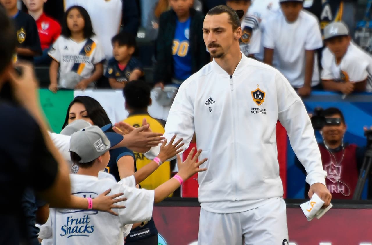 Apr 8, 2018; Carson, CA, USA; Los Angeles Galaxy forward Zlatan Ibrahimovic (9) slaps hands with young fans before the start of the Galaxy's match with the Sporting Kansas City at StubHub Center. Mandatory Credit: Robert Hanashiro-USA TODAY Sports