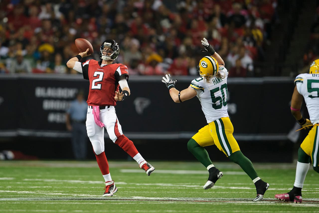 Atlanta Falcons quarterback Matt Ryan (2) attempts a pass while being chased by Green Bay Packers inside linebacker A.J. Hawk (50) during an NFL football game in Atlanta, Georgia, Sunday, Oct. 9, 2011. The Packers won 25-14. (AP Photo/Paul Abell)