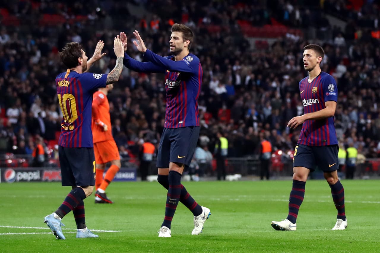 LONDON, ENGLAND - OCTOBER 03: Lionel Messi of Barcelona celebrates with teammate Gerard Pique after scoring his team's fourth goal during the Group B match of the UEFA Champions League between Tottenham Hotspur and FC Barcelona at Wembley Stadium on October 3, 2018 in London, United Kingdom. (Photo by Julian Finney/Getty Images)