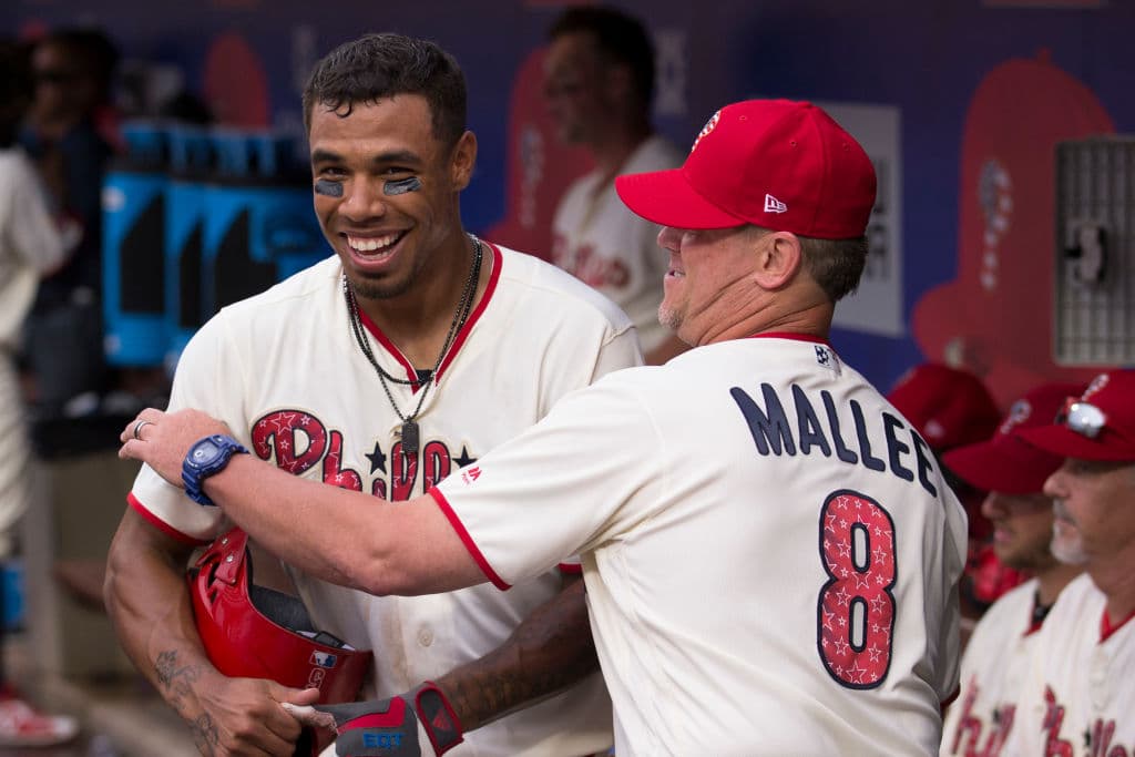 Nick Williams (izq) es felicitado por su coach de bateo, John Mallee, luego de batear un cuadrangular. En el uniforme de ambos se aprencian los detalles especiales y conmemorativos.
