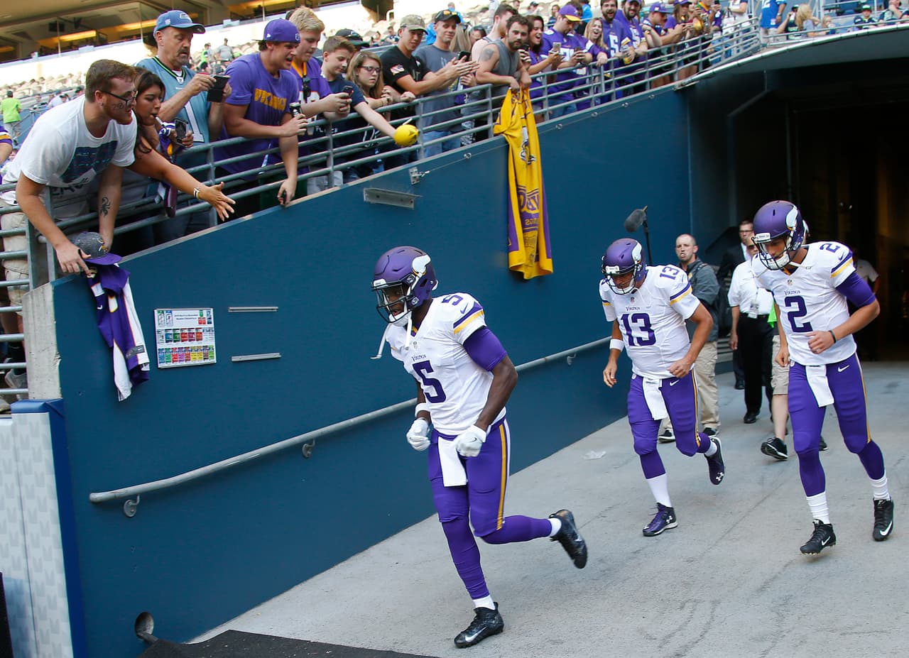 Minnesota Vikings quarterbacks Teddy Bridgewater (5), Joel Stave (2) and Shaun Hill (13) take the field before an NFL preseason game against the Seattle Seahawks at CenturyLink Field on Thursday, August 18, 2016. The Vikings defeated the Seahawks 18-11. (Kevin Terrell via AP)