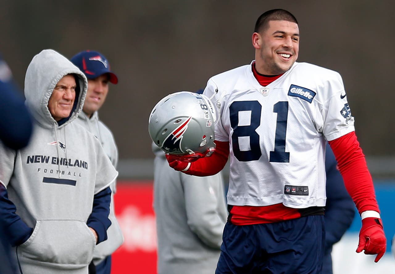 FILE - In this Dec. 19, 2012 file photo, New England Patriots tight end Aaron Hernandez, right, stands on the field with head coach Bill Belichick during NFL football practice at Gillette Stadium in Foxborough, Mass. Jury selection begins for Hernandez's murder trial Friday, Jan. 9, 2015 in Fall River, Mass. He is accused of murder in the death of Odin Lloyd, a 27-year-old semiprofessional football player from Boston who was dating the sister of Hernandez's fiancee. Lloyd was found shot to death June 17, 2013, in an industrial park near Hernandez's home in North Attleborough. (AP Photo/Michael Dwyer, File)