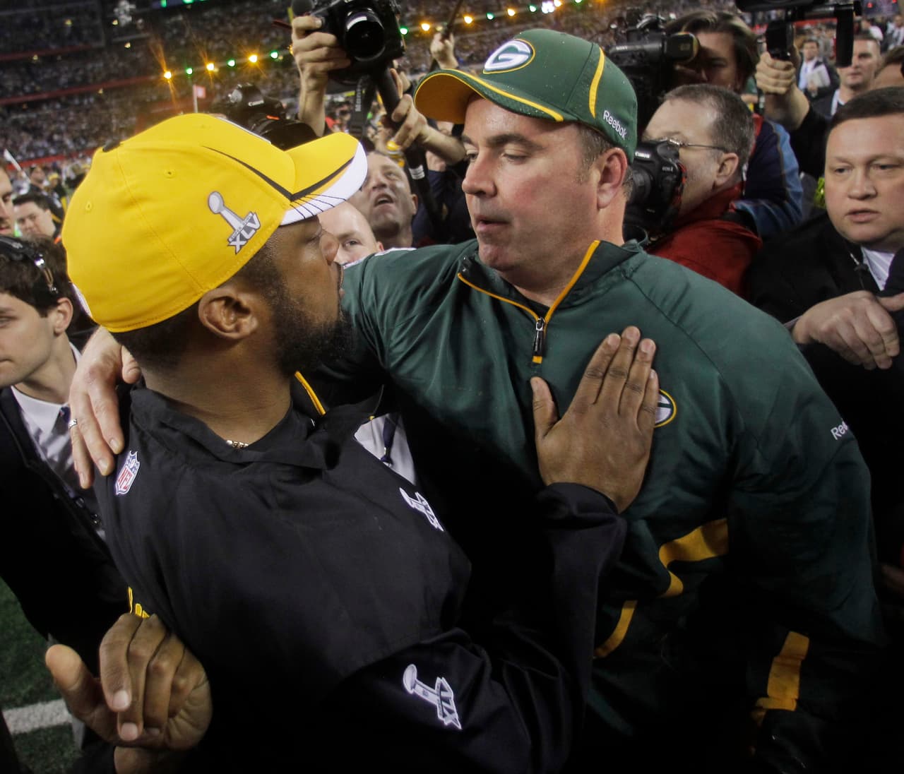 Green Bay Packers head coach Mike McCarthy, right, is congratulated by Pittsburgh Steelers head coach Mike Tomlin after the Packers' 31-25 win in the NFL football Super Bowl XLV football game Sunday, Feb. 6, 2011, in Arlington, Texas. (AP Photo/Dave Martin)