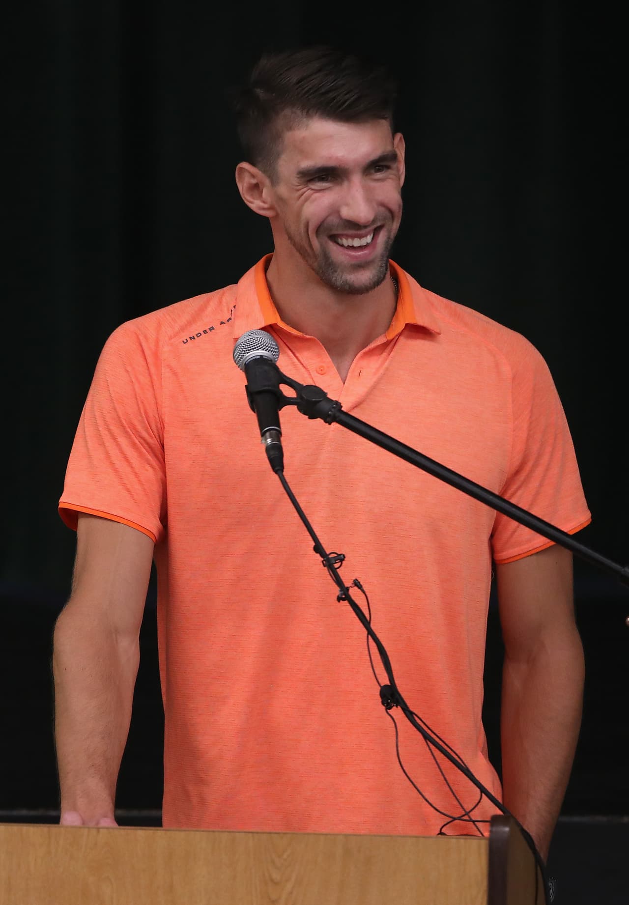 MESA, ARIZONA - AUGUST 28: 28 time Olympic medalist Michael Phelps (R) speaks at a charity swim to honor two-time cancer survivor Cathy Bennett at Kino Aquatic Center on August 28, 2019 in Mesa, Arizona. Cathy taught Michael how to swim, and is the Program Director for Michael Phelps Foundation. (Photo by Christian Petersen/Getty Images)