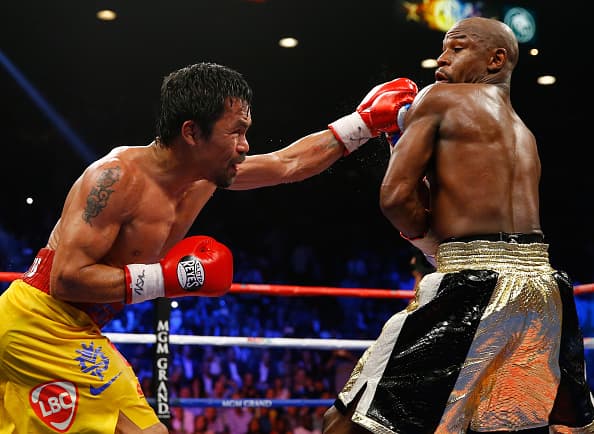LAS VEGAS, NV - MAY 02: Manny Pacquiao throws a left at Floyd Mayweather Jr. during their welterweight unification championship bout on May 2, 2015 at MGM Grand Garden Arena in Las Vegas, Nevada. (Photo by Al Bello/Getty Images)