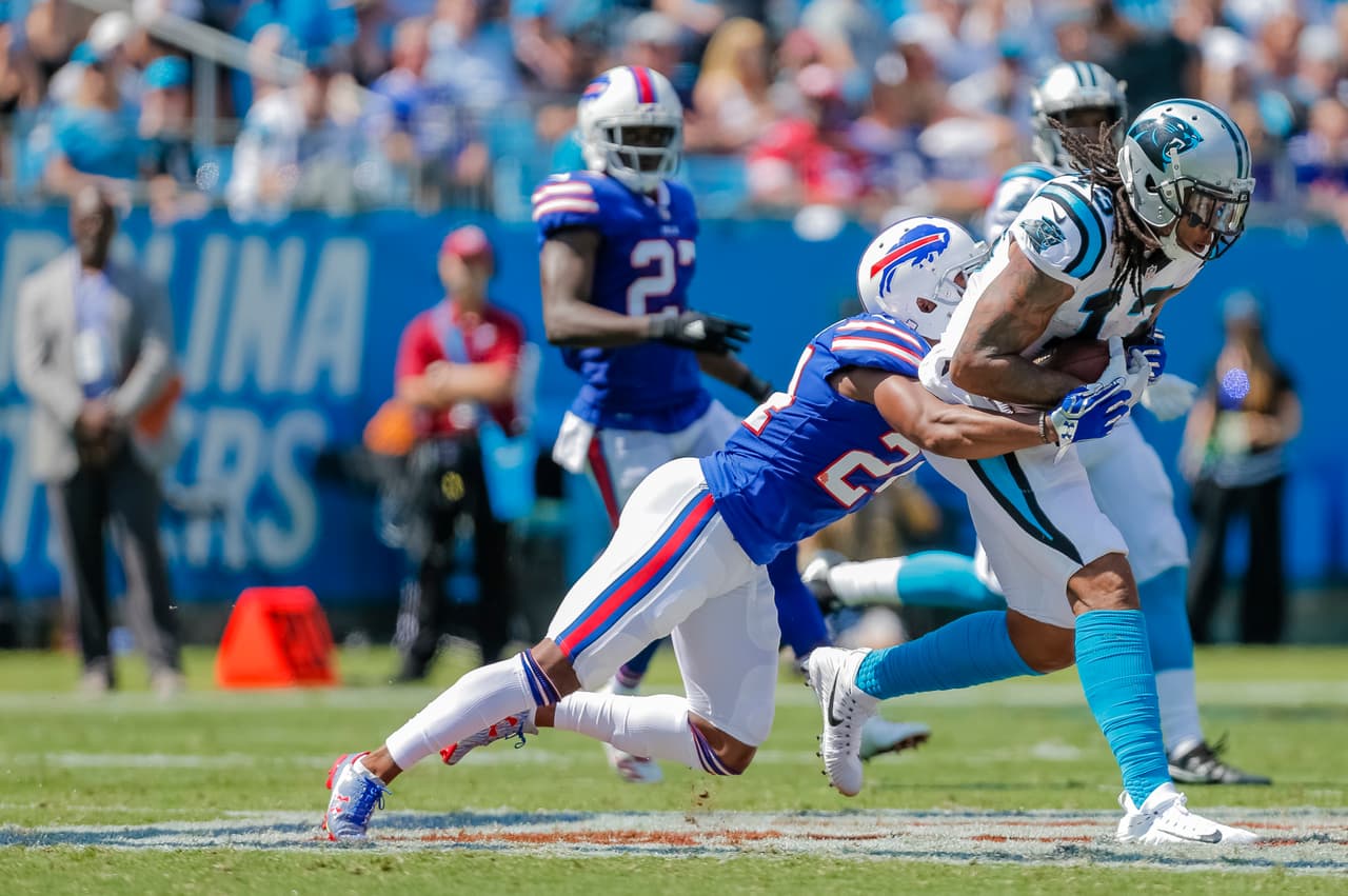 Carolina Panthers' Kelvin Benjamin (13) protects a pass as Buffalo Bills' Leonard Johnson (24) grabs on for a tackle during the first half of an NFL football game in Charlotte, N.C., Sunday, Sept. 17, 2017. The Panthers won 9-3. (AP Photo/Bob Leverone)