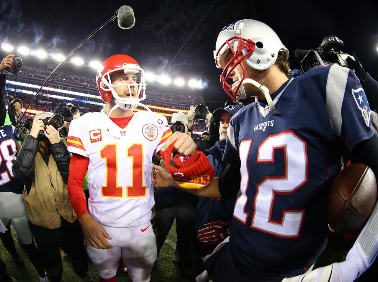 FOXBORO, MA - JANUARY 16: Alex Smith #11 of the Kansas City Chiefs and Tom Brady #12 of the New England Patriots speak after the AFC Divisional Playoff Game at Gillette Stadium on January 16, 2016 in Foxboro, Massachusetts. The Patriots defeated the Chiefs 27-20. (Photo by Maddie Meyer/Getty Images)