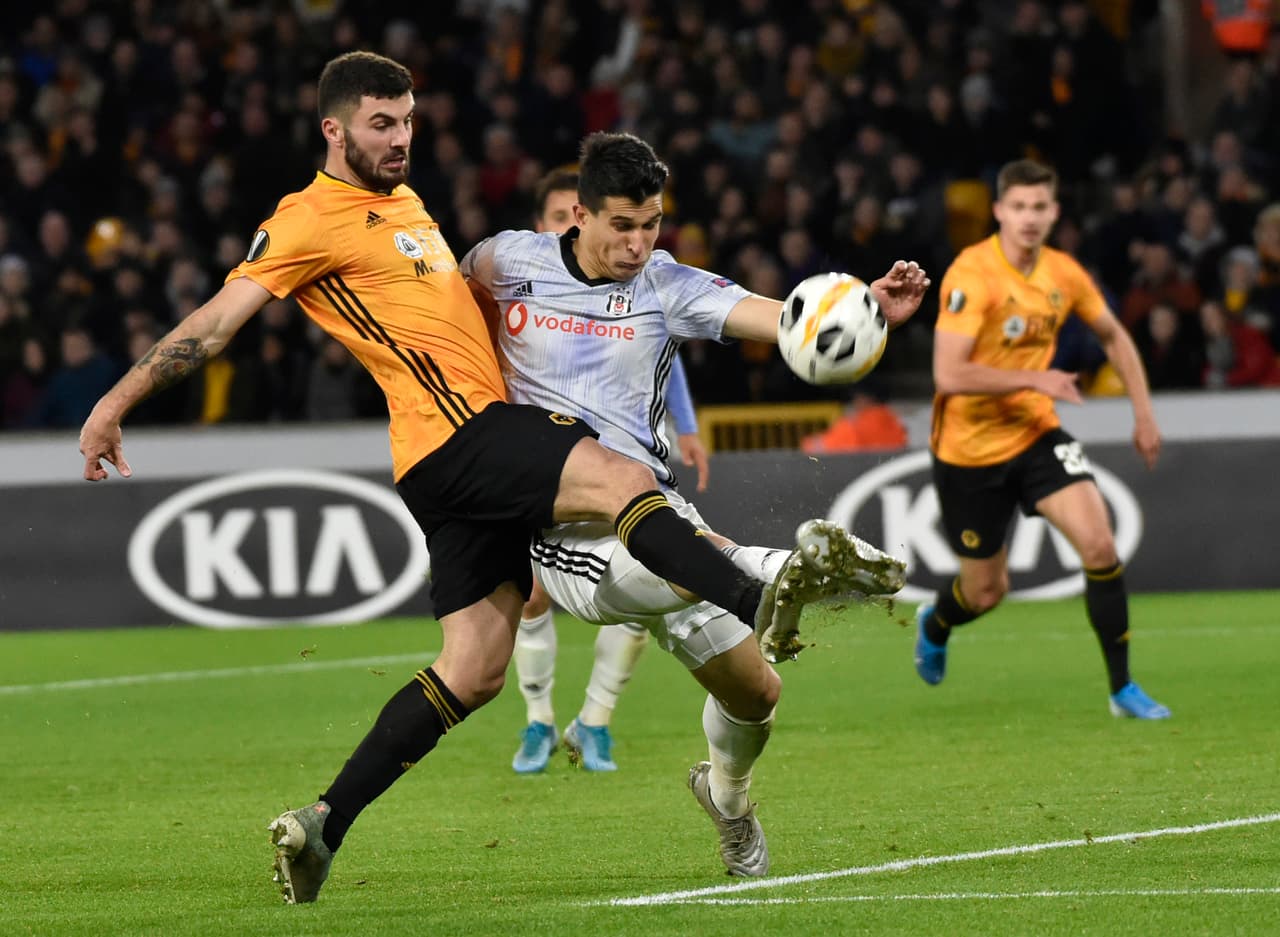 Wolverhampton Wanderers' Patrick Cutrone, left, and Besiktas' Necip Uysal battle for the ball during the Europa League group K soccer match between Wolverhampton Wanderers and Besiktas at the Molineux Stadium, in Wolverhampton, England, Thursday Dec. 12, 2019. (AP Photo/ Rui Vieira)
