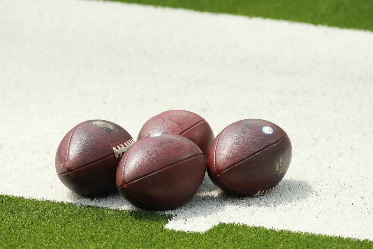 INGLEWOOD, CALIFORNIA - AUGUST 27: Footballs sit on the field ready for play during Los Angeles Chargers Training Camp at Sofi Stadium on August 27, 2020 in Inglewood, California. (Photo by Joe Scarnici/Getty Images)