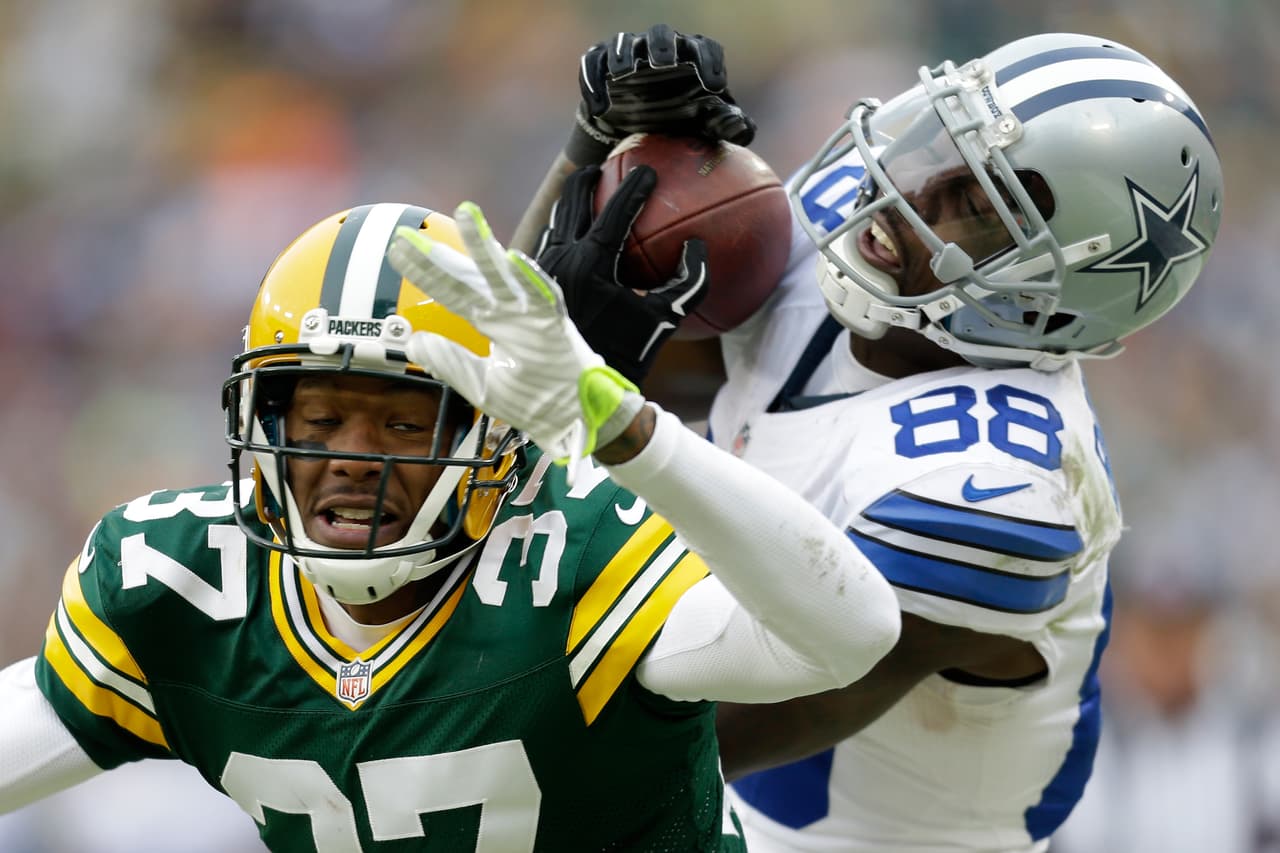 GREEN BAY, WI - JANUARY 11: Dez Bryant #88 of the Dallas Cowboys attempts a catch over Sam Shields #37 of the Green Bay Packers during the 2015 NFC Divisional Playoff game at Lambeau Field on January 11, 2015 in Green Bay, Wisconsin. Initially ruled a catch, the call was reversed upon review. (Photo by Mike McGinnis/Getty Images)