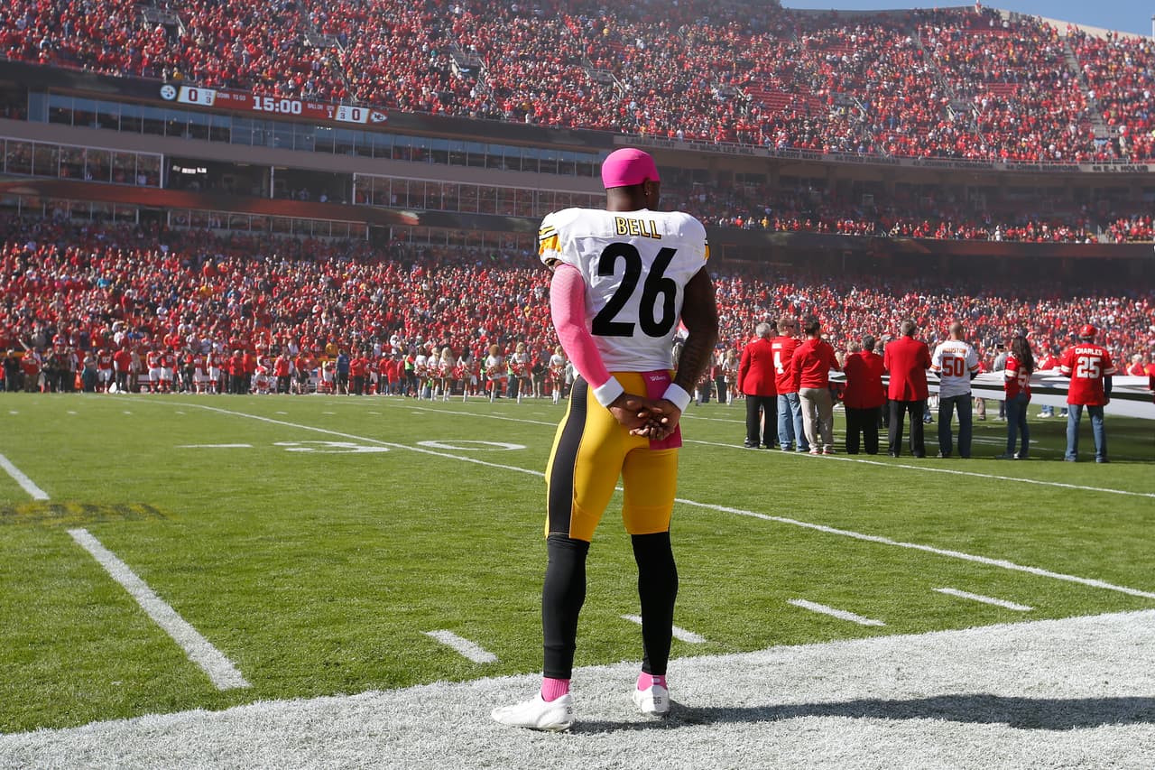 Pittsburgh Steelers running back Le'Veon Bell (26) stands on the sideline as the National Anthem is sung as seen from field level during a week 7 NFL football game between the Pittsburgh Steelers against the Kansas City Chiefs on Sunday, October 25, 2015 in Kansas City, Missouri. The Chiefs defeated the Steelers 23-13. (Scott Boehm via AP)