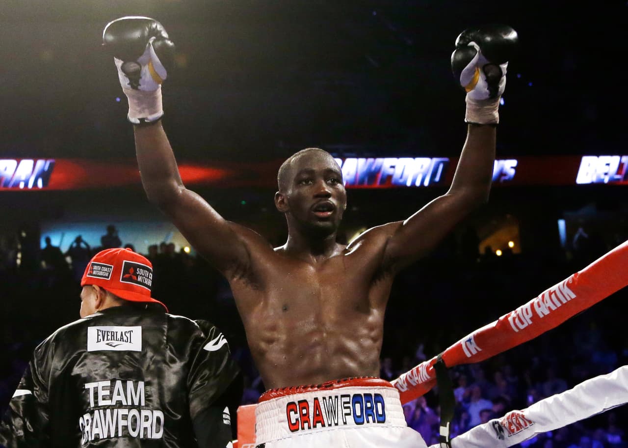 FILE - This Nov. 30, 2014, file photo shows Terence Crawford celebrating after defeating Raymundo Beltran to retain his WBO lightweight title in a boxing match in Omaha, Neb. Lightweight Terence "Bud" Crawford, who won three fights in 2014, has been voted fighter of the year by the Boxing Writers Association of America. (AP Photo/Nati Harnik, File)