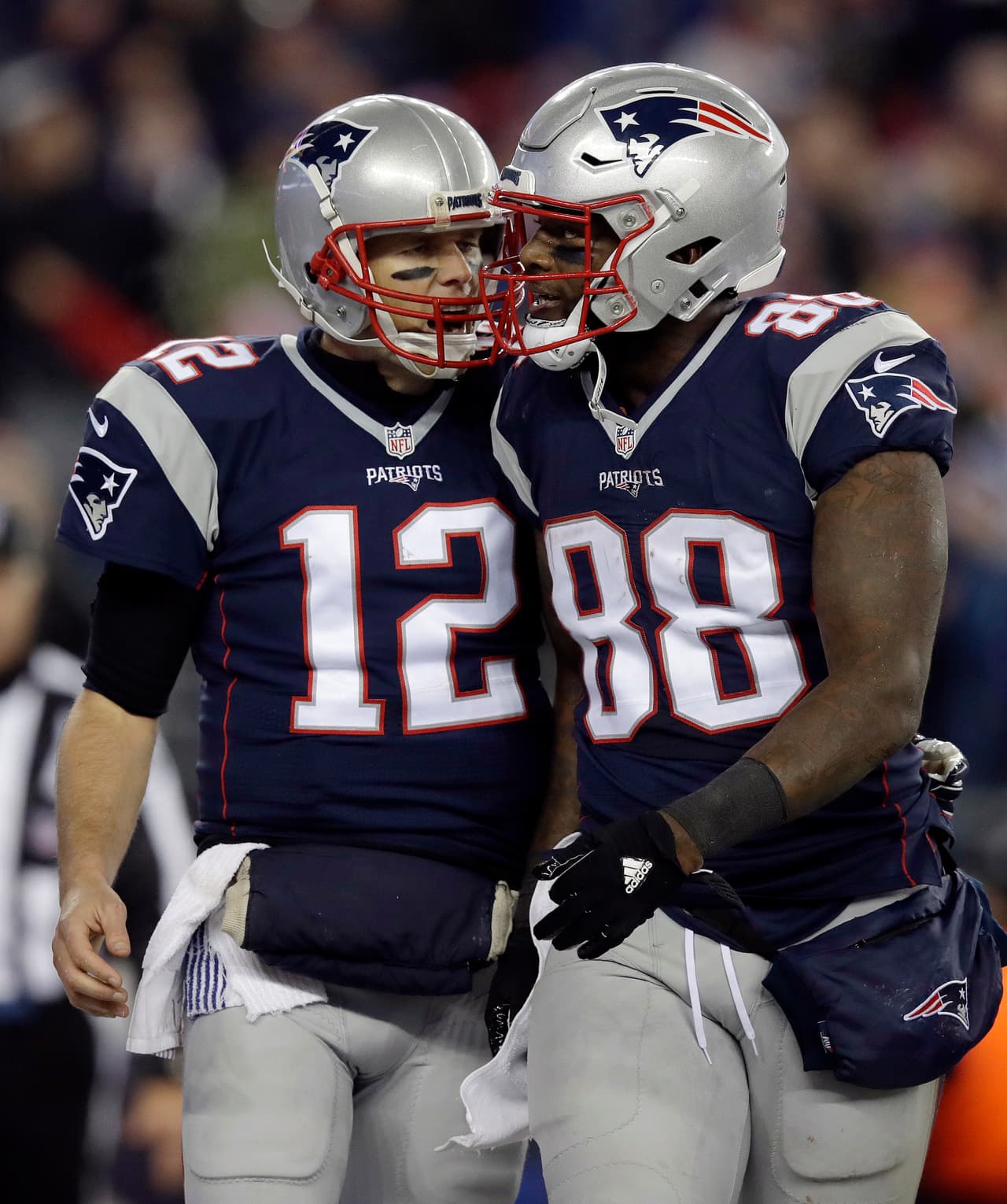 New England Patriots quarterback Tom Brady (12) celebrates his touchdown pass to tight end Martellus Bennett (88) during the second half of an NFL football game against the Baltimore Ravens, Monday, Dec. 12, 2016, in Foxborough, Mass. (AP Photo/Charles Krupa)