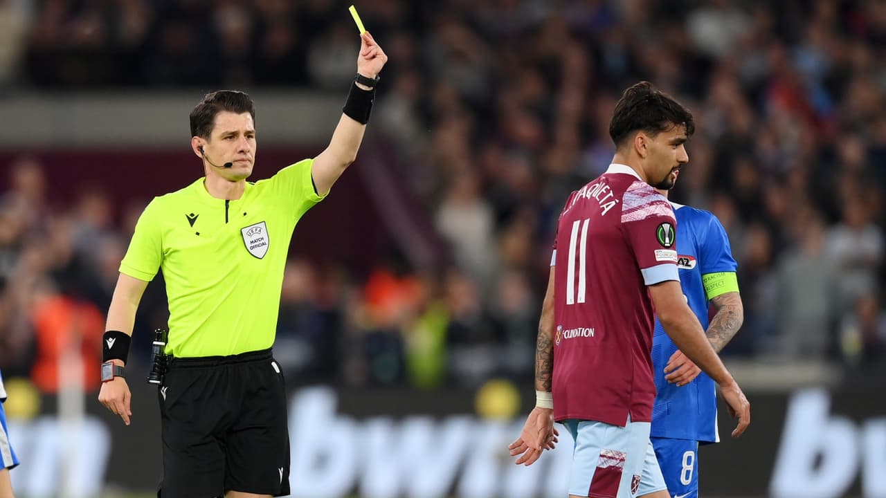 Referee Halil Umut Meler awards a yellow card to Lucas Paqueta during the UEFA Europa Conference League semi-final first leg match between West Ham United and AZ Alkmaar.