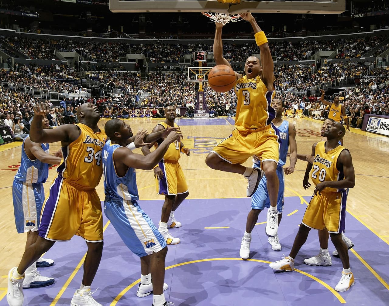 LOS ANGELES - DECEMBER 19: Devean George #3 the Los Angeles Lakers slams dunks in front of Shaquille O'Neal #34 and Gary Payton #20 and Rodney White #5 of the Denver Nuggets on December 19, 2003 at Staples Center in Los Angeles, California. The Lakers won 94-92. NOTE TO USER: User Expressly acknowledges and agrees that, by downloading and or using this photograph, User is consenting to the terms and conditions of the Getty Images License Agreement. (Photo by Stephen Dunn/Getty Images)