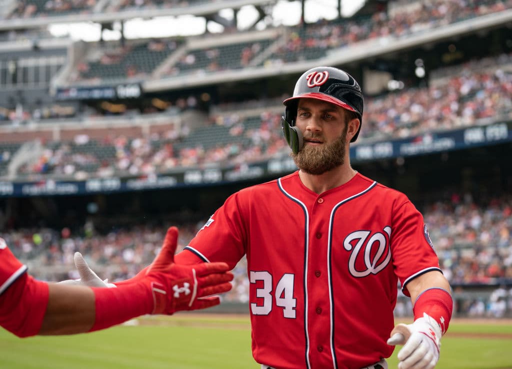 ATLANTA, GA - SEPTEMBER 16: Bryce Harper #34 of the Washington Nationals is greeted with high fives by teammates after hitting a two run home run in the first inning agains the Atlanta Braves at SunTrust Park on September 16, 2018 in Atlanta, Georgia.(Photo by Kelly Kline/Getty Images)