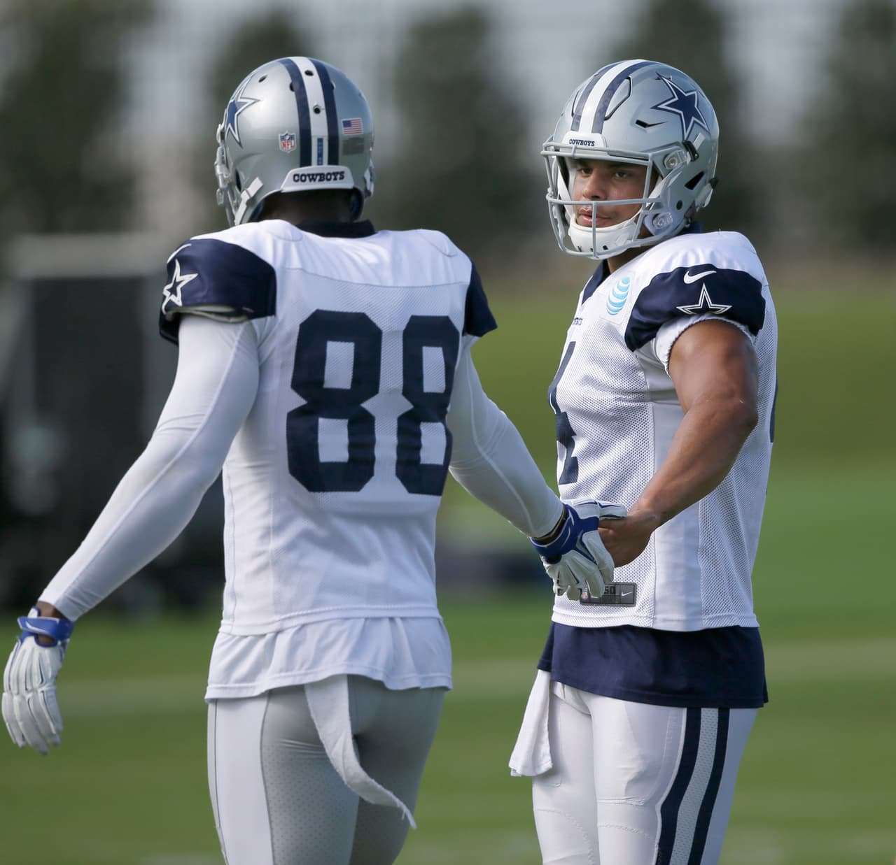 Dallas Cowboys quarterback Dak Prescott (4) and wife receiver Dez Bryant touch hands during a drill at the team's practice facility in Frisco, Texas, Wednesday, Oct. 26, 2016. (AP Photo/LM Otero)
