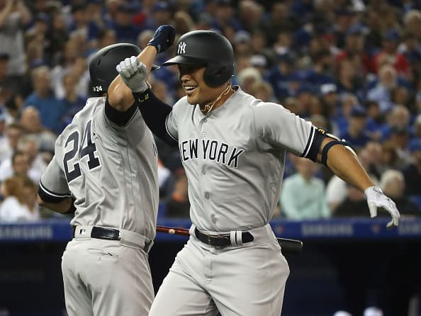TORONTO, ON- MARCH 29 - New York Yankees right fielder Giancarlo Stanton (27) celebrates his first inning home run as the Toronto Blue Jays open the season against the New York Yankees with a 6-1 loss at Rogers Centre in Toronto. March 29, 2018. (Steve Russell/Toronto Star via Getty Images)