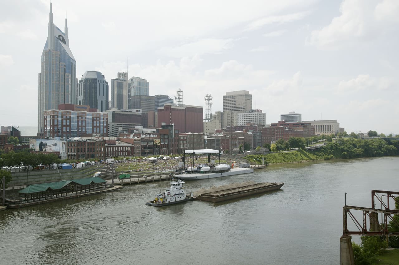 NASHVILLE - JUNE 10: The skyline of Nashville is seen with riverfront concert stage and midway during the 2004 CMA Music Festival, formerly known as FanFair June 10, 2004 in Nashville, Tenessee. The four-day festival is the largest in country music. (Photo by Rusty Russell/Getty Images)