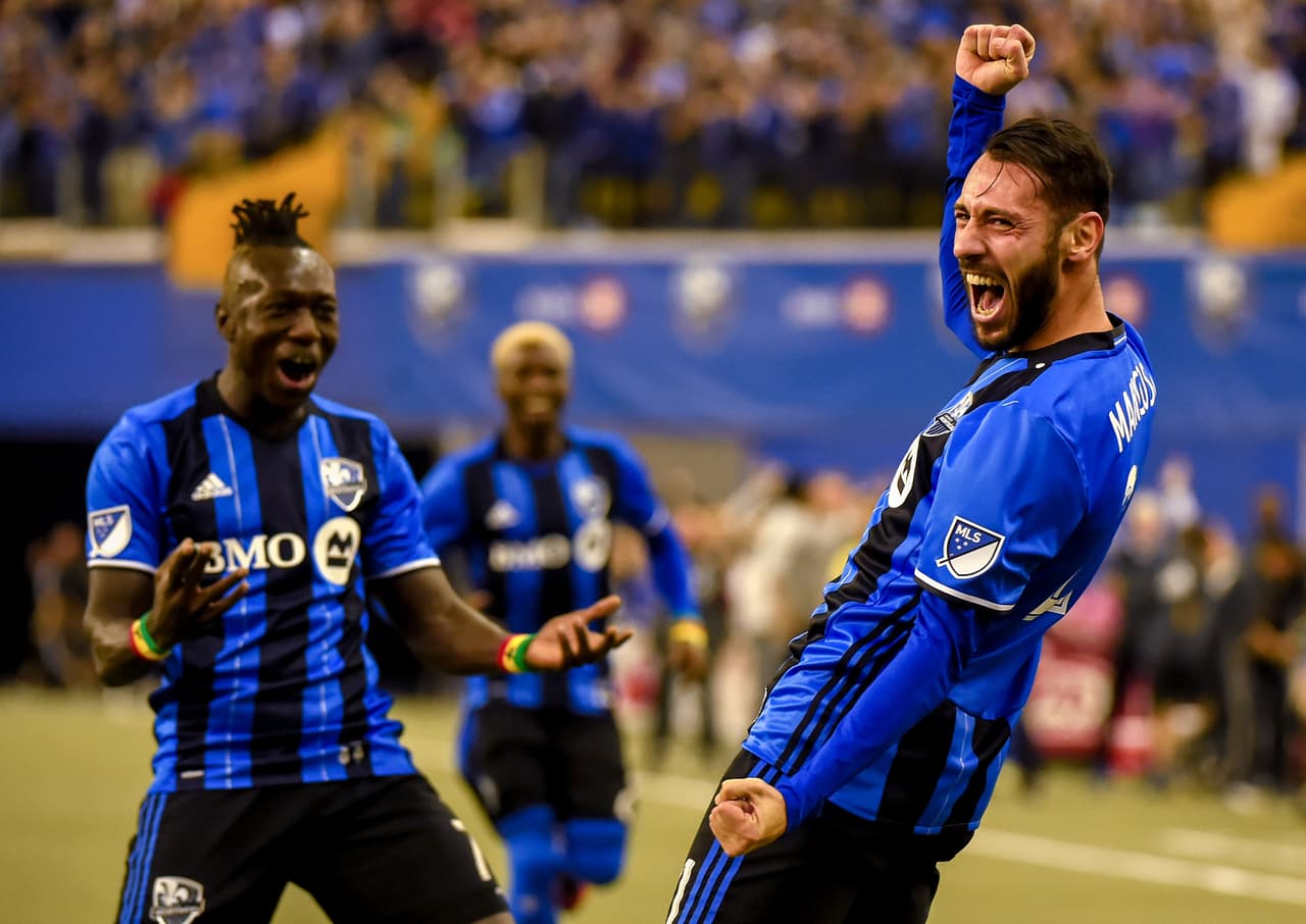 Nov 22, 2016; Montreal, Quebec, CAN; Montreal Impact forward Mateo Mancosu (21) celebrates his first half goal against Toronto FC with forward Dominic Oduro (7) in the first leg of the MLS Eastern Conference Championship at Olympic Stadium. Mandatory Credit: Dan Hamilton-USA TODAY Sports