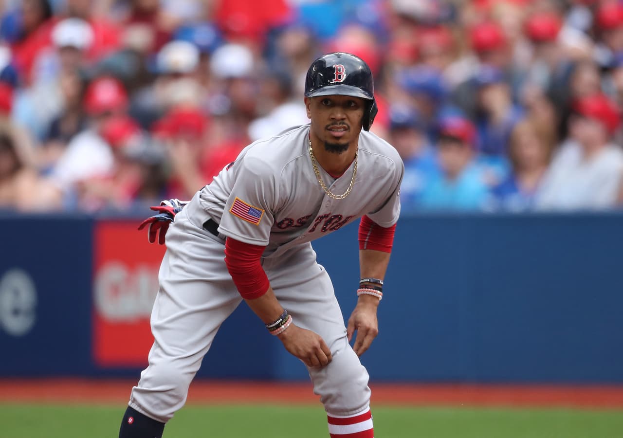 TORONTO, ON - JULY 1: Mookie Betts #50 of the Boston Red Sox leads off first base before stealing second base on the upcoming pitch in the fifth inning during MLB game action against the Toronto Blue Jays at Rogers Centre on July 1, 2017 in Toronto, Canada. (Photo by Tom Szczerbowski/Getty Images)