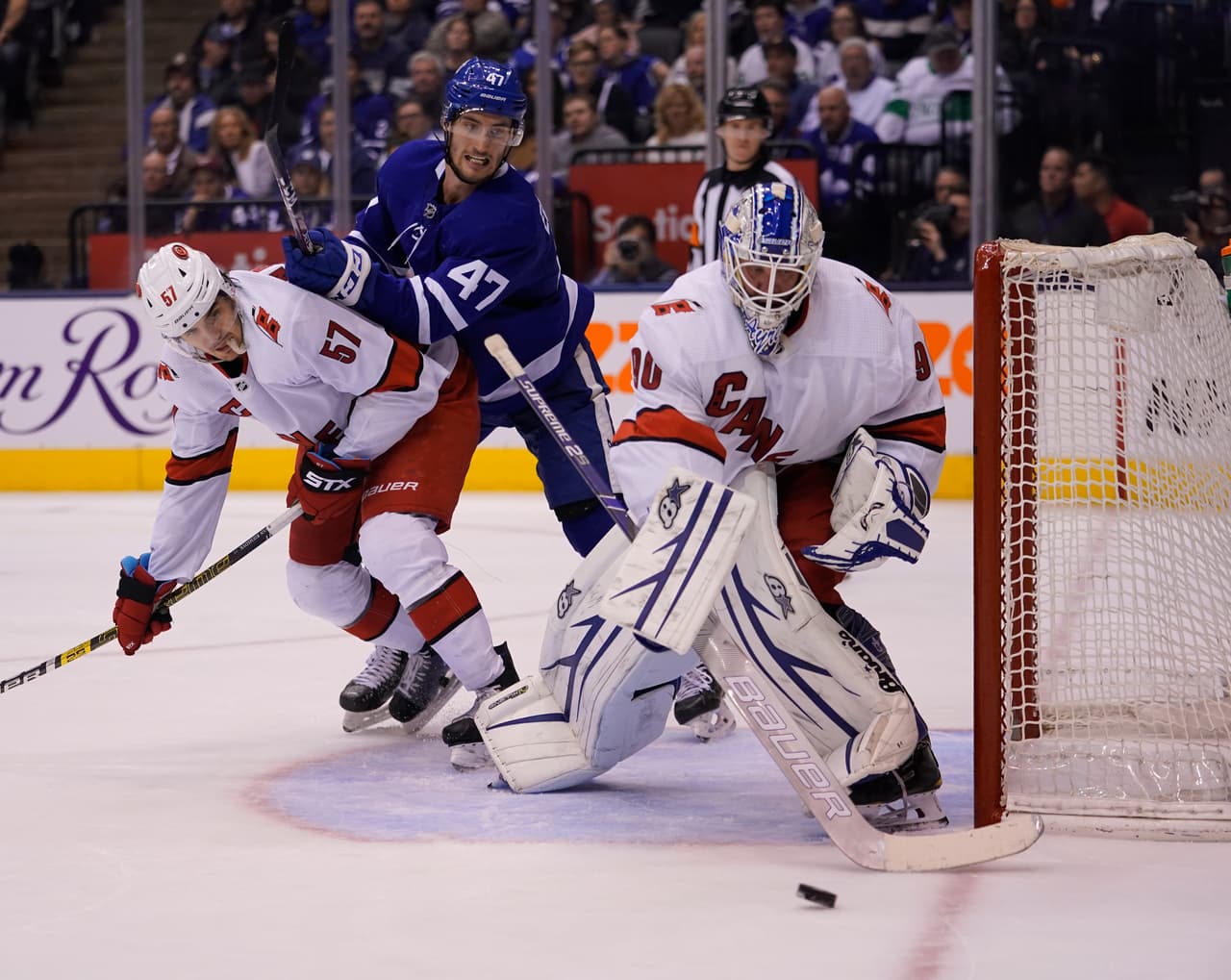 Feb 22, 2020; Toronto, Ontario, CAN; Carolina Hurricanes emergency goaltender David Ayres (90) clears the puck as Toronto Maple Leafs forward Pierre Engvall (47) and Carolina Hurricanes defenseman Trevor van Riemsdyk (57) battle for position at Scotiabank Arena. Carolina defeated Toronto. Mandatory Credit: John E. Sokolowski-USA TODAY Sports