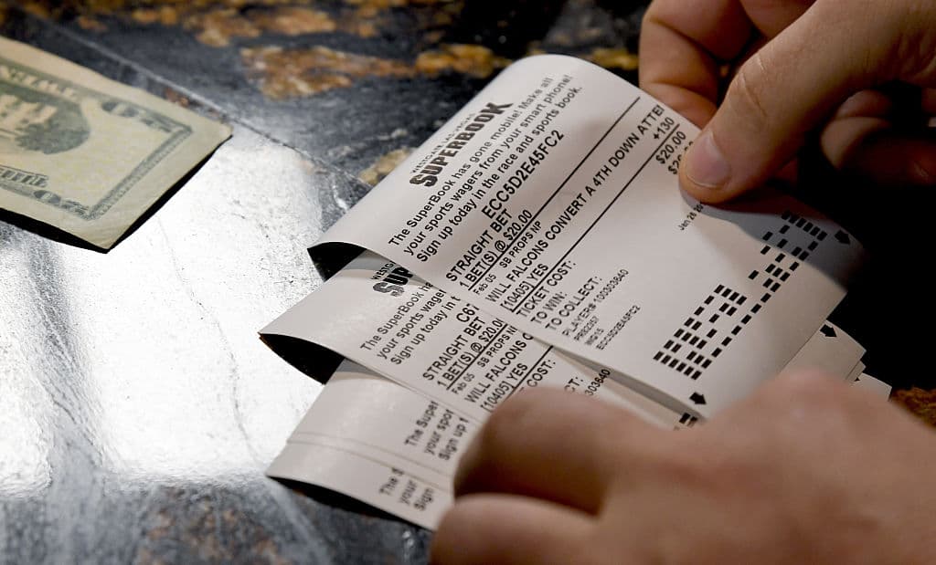 LAS VEGAS, NV - JANUARY 26: A bettor places wagers on some of the more than 400 proposition bets for Super Bowl LI between the Atlanta Falcons and the New England Patriots at the Race & Sports SuperBook at the Westgate Las Vegas Resort & Casino on January 26, 2017 in Las Vegas, Nevada. (Photo by Ethan Miller/Getty Images)