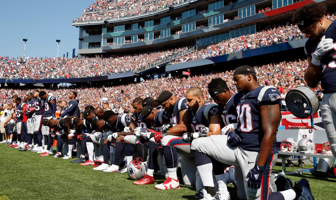 Several New England Patriots players kneel during the national anthem before an NFL football game against the Houston Texans, Sunday, Sept. 24, 2017, in Foxborough, Mass. (AP Photo/Michael Dwyer)