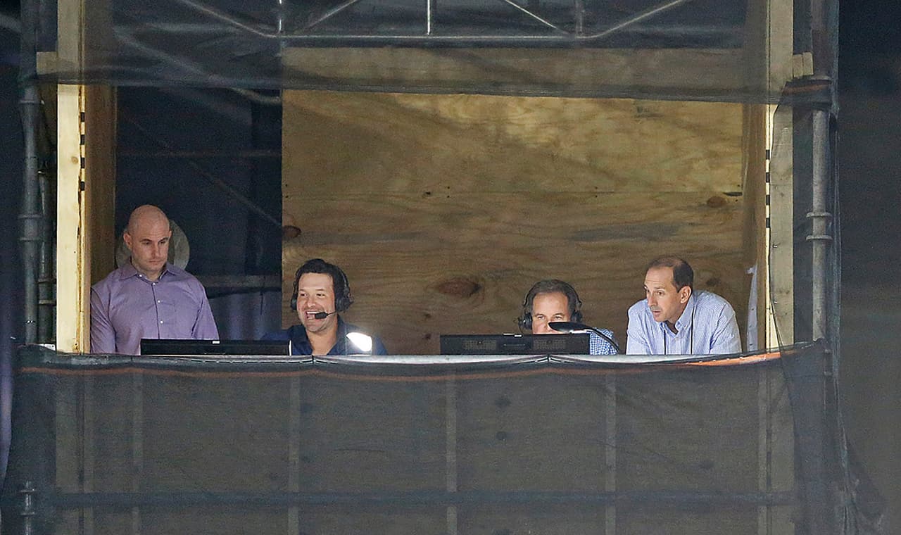 CBS Sports announcers Tony Romo (second from left) and Jim Nantz (second from right) practice calling the game during the 2017 NFL Pro Football Hall of Fame preseason football game against the Arizona Cardinals on Thursday, Aug. 3, 2017 in Canton, Ohio. The Cowboys defeated the Cardinals, 20-18. (James D. Smith via AP)
