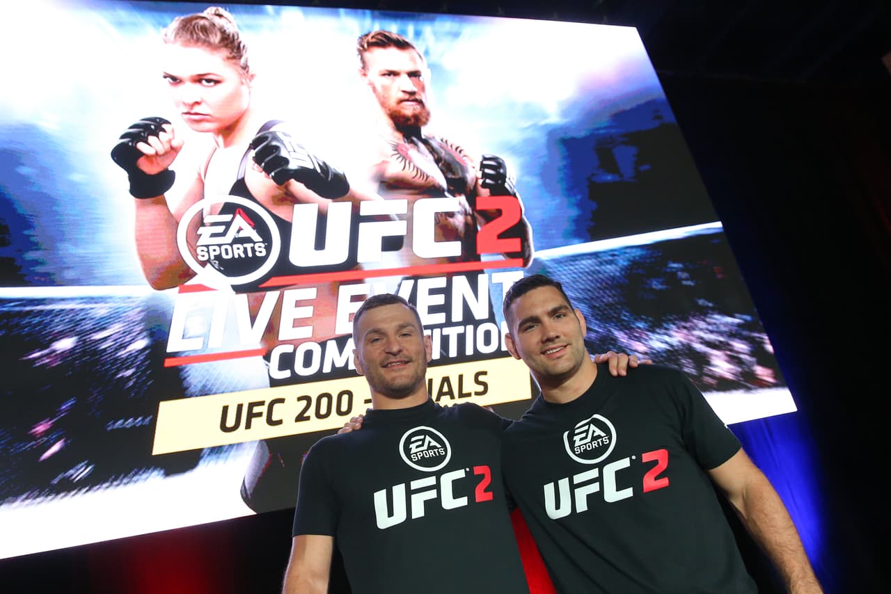 LAS VEGAS, NV - JULY 08: UFC heavyweight champion Stipe Miocic (L) and Chris Weidman act as cornermen for the EA Sports UFC 2 Live Event Competition finals during day 1 of the UFC Fan Expo at the Las Vegas Convention Center on July 8, 2016 in Las Vegas, Nevada. (Photo by Ed Mulholland/Zuffa LLC/Zuffa LLC via Getty Images)