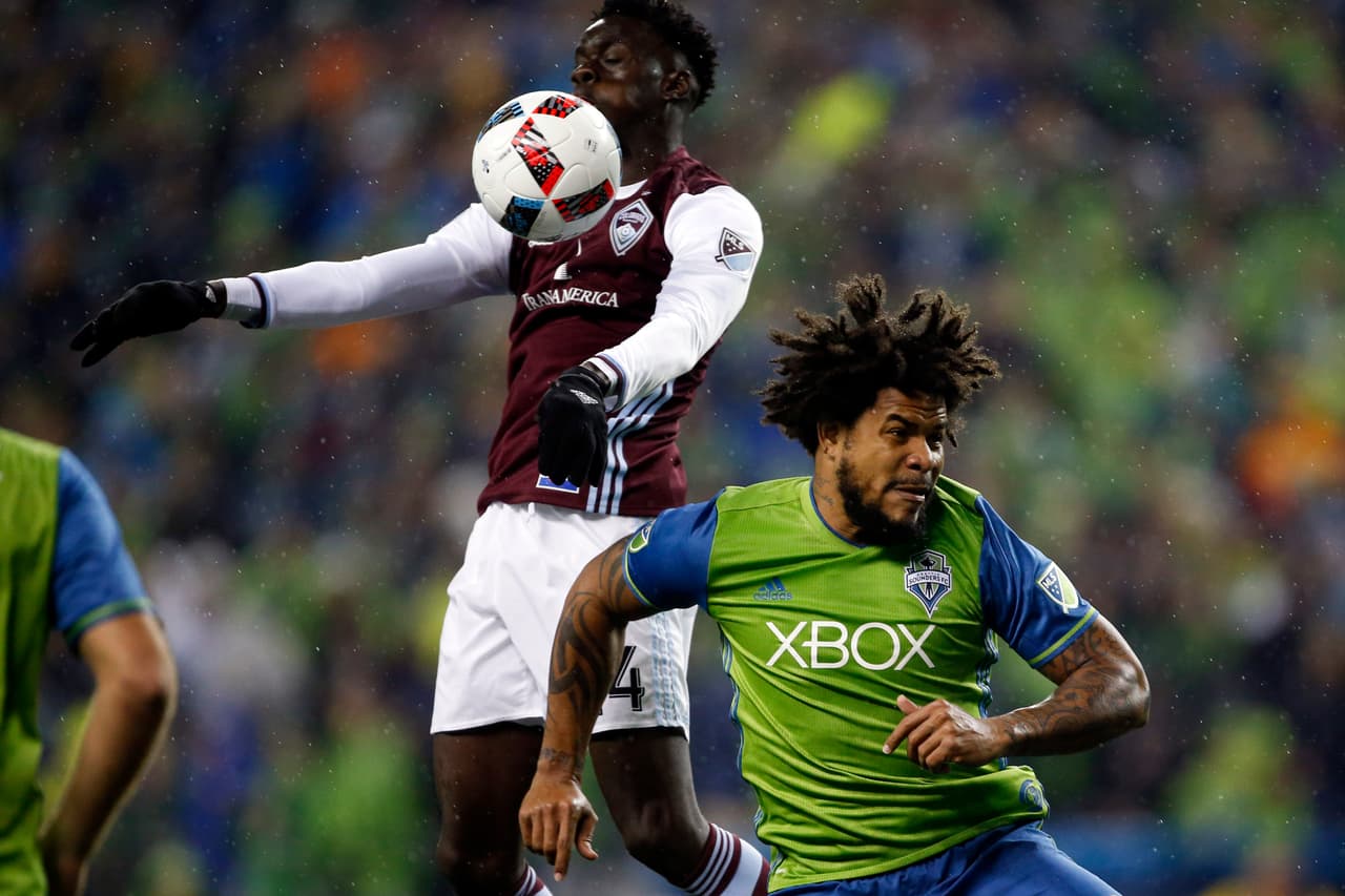 Nov 22, 2016; Seattle, WA, USA; Colorado Rapids midfielder Dominique Badji (14) chests down the ball above Seattle Sounders FC defender Roman Torres (29) during the first half in the first leg of the MLS Western Conference Championship at CenturyLink Field. Mandatory Credit: Jennifer Buchanan-USA TODAY Sports