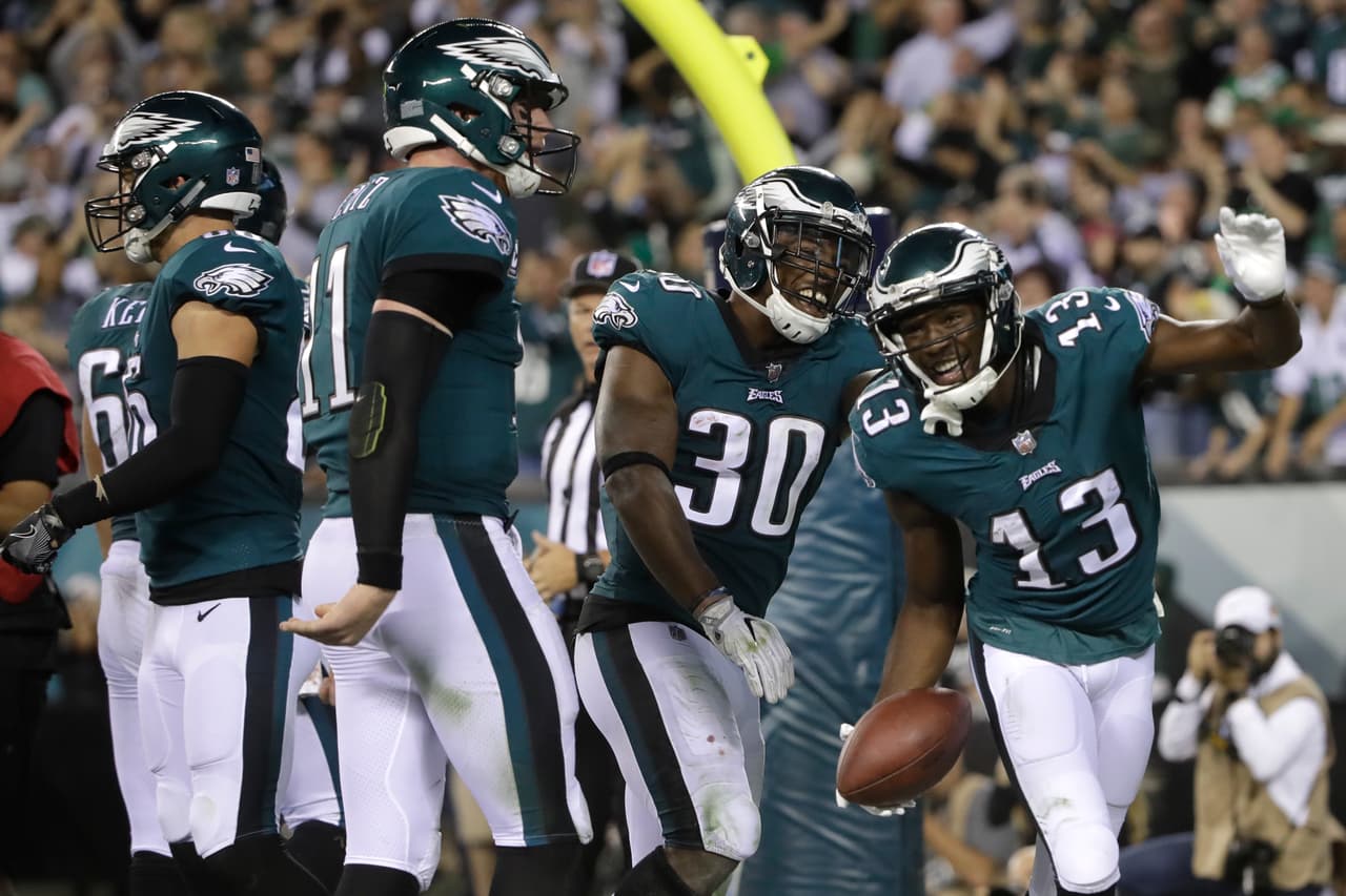 Philadelphia Eagles wide receiver Nelson Agholor (13) celebrates with teammates, after catching a touchdown pass form quarterback Carson Wentz, second form left, during the second half of an NFL football game against the Washington Redskins, Monday, Oct. 23, 2017, in Philadelphia. (AP Photo/Matt Rourke)