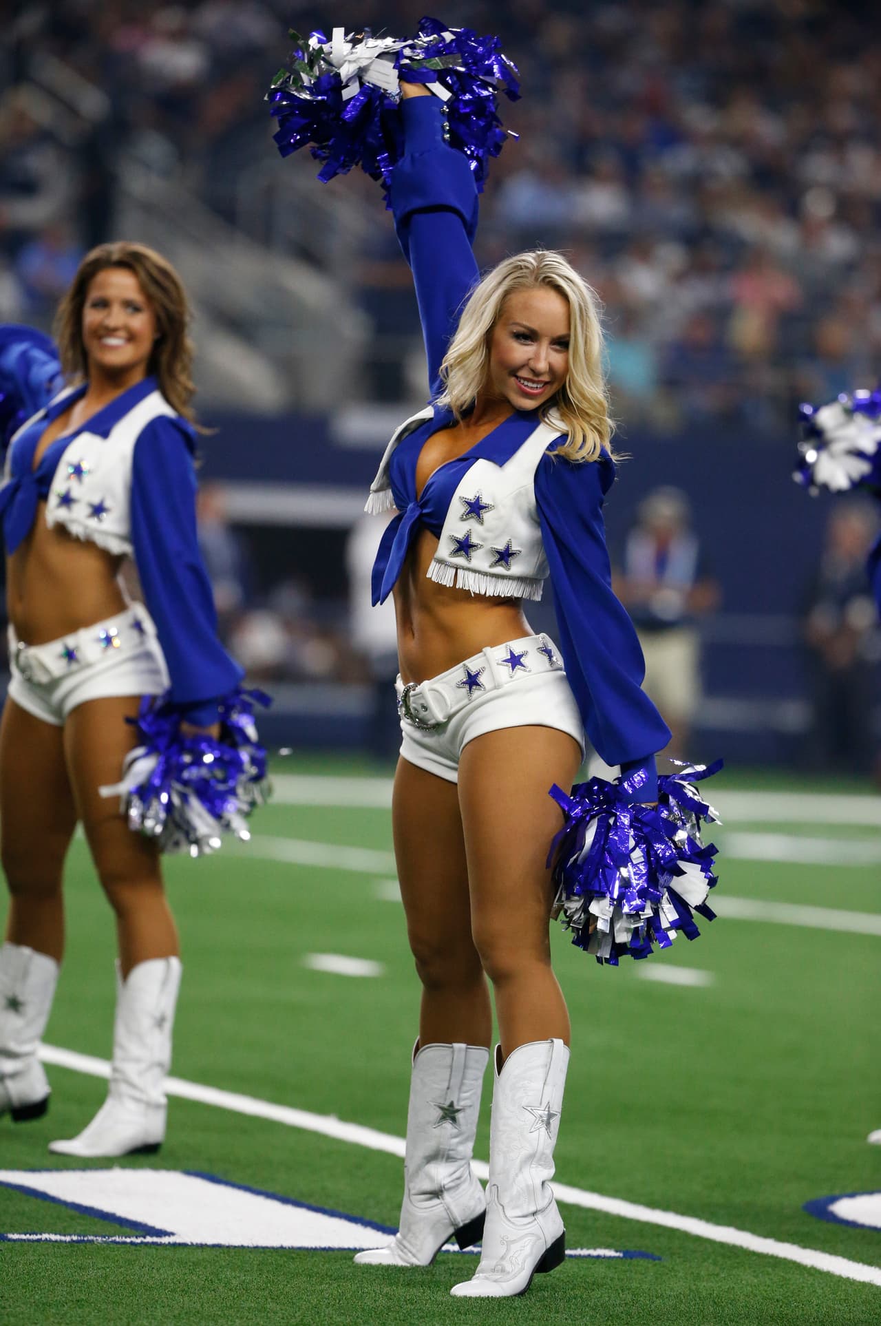 Dallas Cowboys cheerleaders perform during the first half of a preseason NFL football game between the Dallas Cowboys and the Arizona Cardinals in Arlington, Texas, Sunday, Aug. 26, 2018. (AP Photo/Michael Ainsworth)